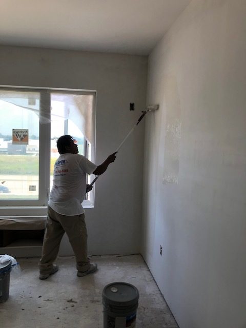 commercial wall painter in action