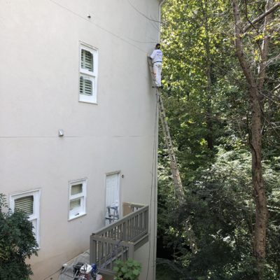 painter painting on ladder